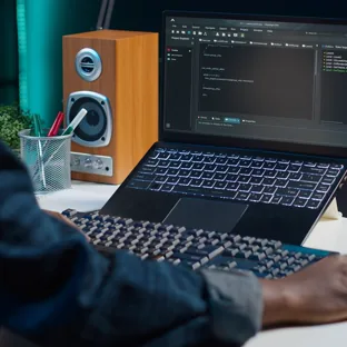 A developer writing code on a laptop